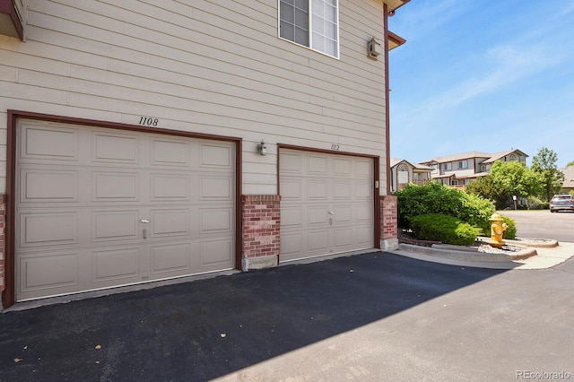 11085 Huron St Unit 1108, Northglenn, CO 80234 - garage featuring asphalt driveway