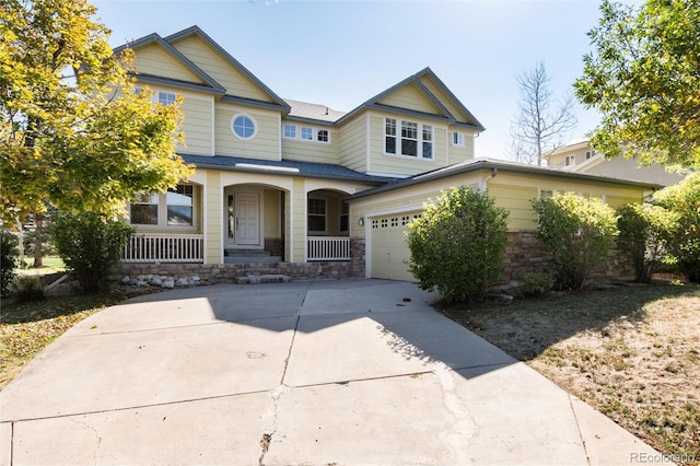 craftsman inspired home with a porch and a garage