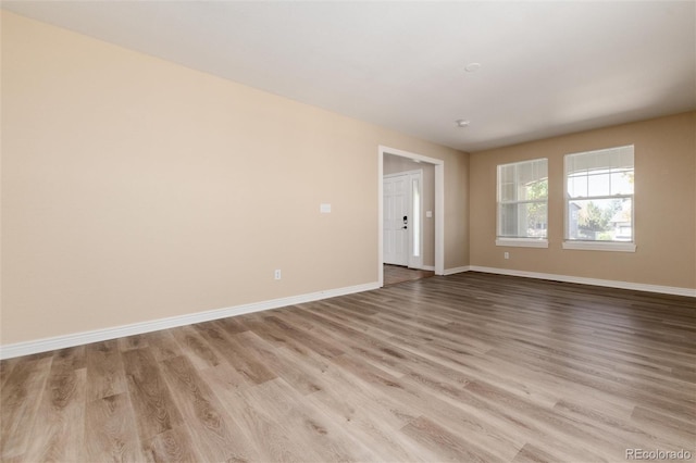 spare room with light wood-type flooring