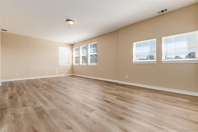 unfurnished room with a wealth of natural light and light wood-type flooring