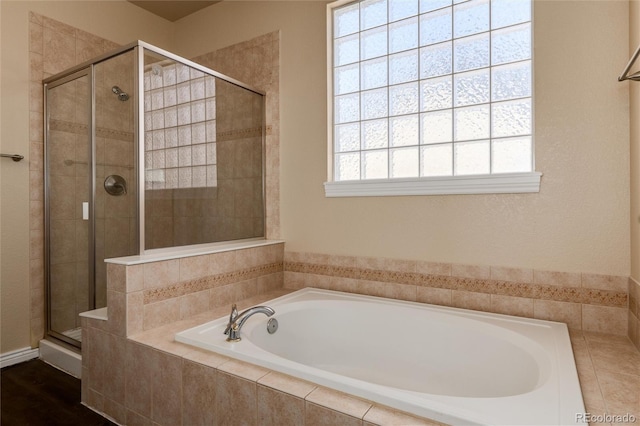 bathroom featuring independent shower and bath