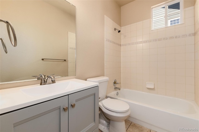 full bathroom featuring vanity, tiled shower / bath combo, toilet, and tile patterned floors