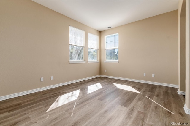 spare room with wood-type flooring