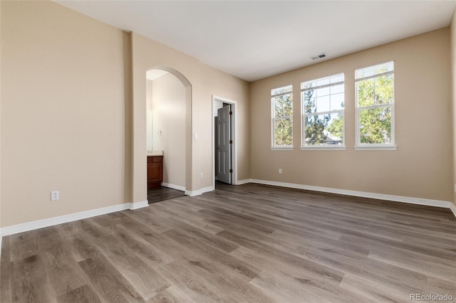 unfurnished room with hardwood / wood-style flooring