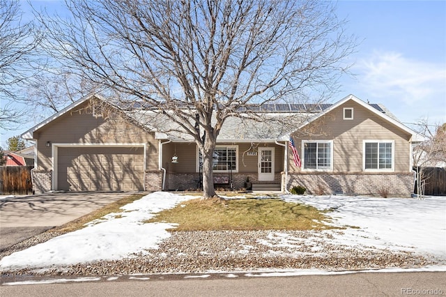 single story home with concrete driveway, brick siding, fence, and an attached garage