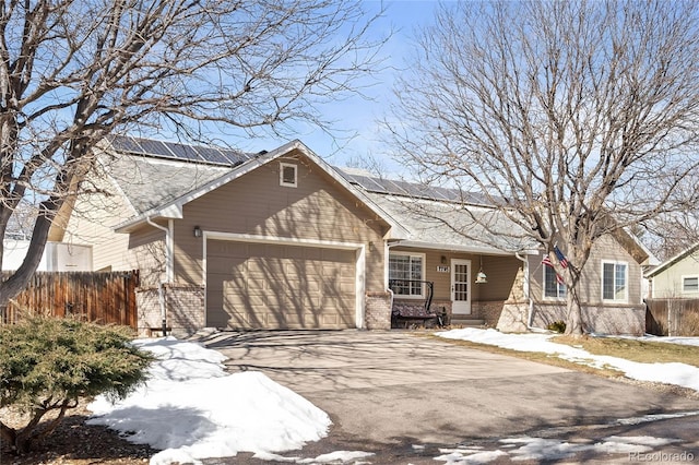 ranch-style house with a garage, brick siding, fence, and driveway