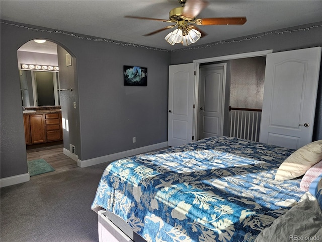 bedroom featuring carpet, connected bathroom, and ceiling fan