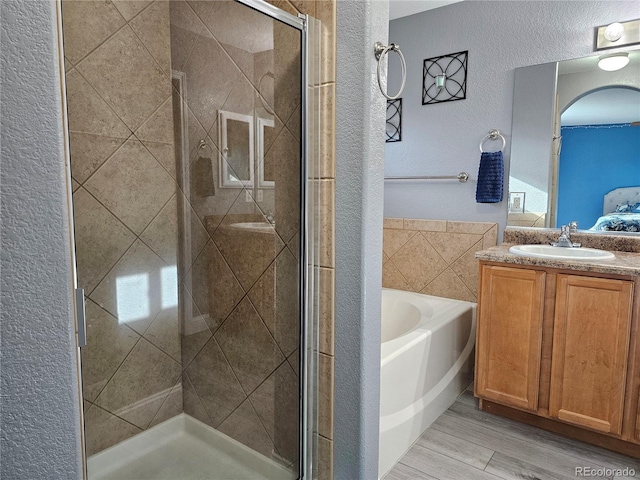 bathroom with plus walk in shower and vanity