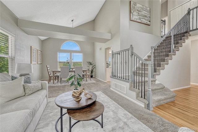 901 Sage Sparrow Cir, Highlands Ranch, CO 80129 - living area featuring stairs, baseboards, high vaulted ceiling, and wood finished floors