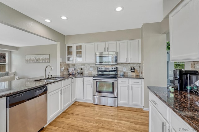 901 Sage Sparrow Cir, Highlands Ranch, CO 80129 - kitchen featuring stainless steel appliances, a sink, white cabinetry, dark stone countertops, and recessed lighting