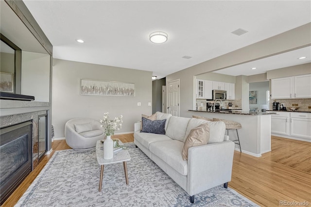 901 Sage Sparrow Cir, Highlands Ranch, CO 80129 - living room with light wood-style floors, a fireplace, recessed lighting, and baseboards