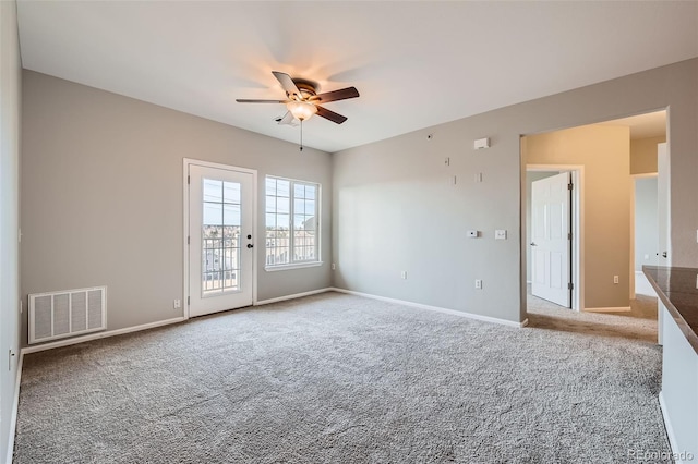 2705 S Danube Way Unit 306, Aurora, CO 80013 - empty room with a ceiling fan, carpet flooring, and baseboards