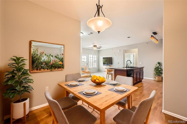 2705 S Danube Way Unit 306, Aurora, CO 80013 - dining space with baseboards, light wood-style floors, and a ceiling fan