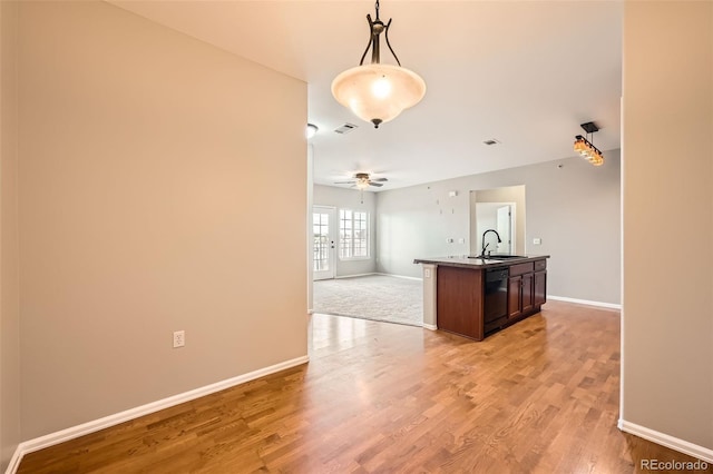 2705 S Danube Way Unit 306, Aurora, CO 80013 - kitchen with a sink, open floor plan, dishwasher, and baseboards