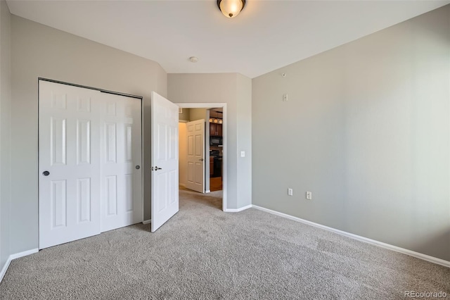 2705 S Danube Way Unit 306, Aurora, CO 80013 - unfurnished bedroom featuring carpet floors, baseboards, and a closet