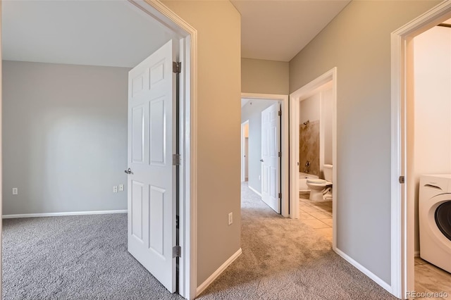 2705 S Danube Way Unit 306, Aurora, CO 80013 - hallway featuring washer / clothes dryer, carpet floors, and baseboards