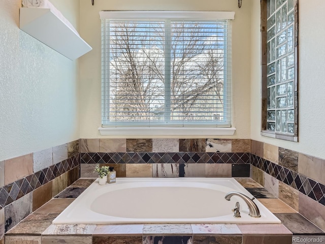 full bathroom with plenty of natural light and a garden tub