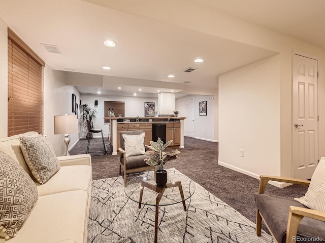 living room with visible vents, baseboards, dark colored carpet, and recessed lighting