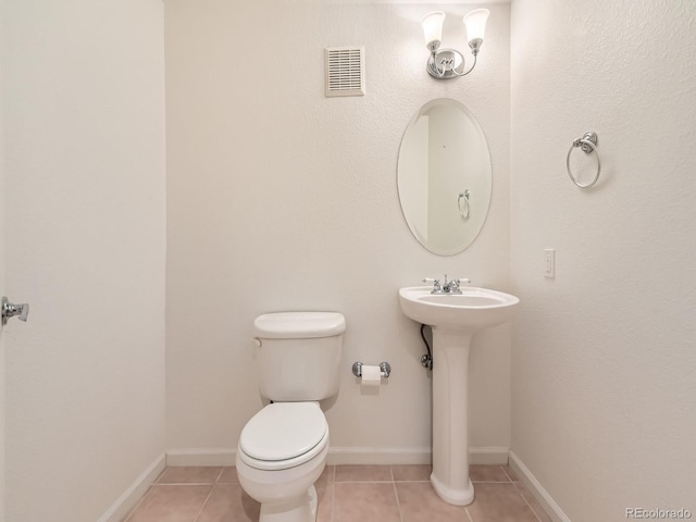 bathroom with visible vents, toilet, baseboards, and tile patterned floors