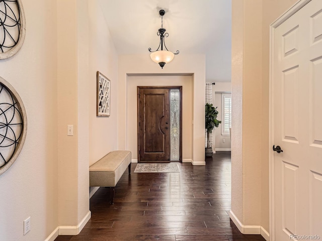 entrance foyer with dark wood-style floors and baseboards