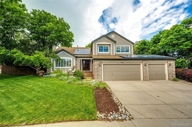 view of front of house featuring concrete driveway, brick siding, fence, and solar panels