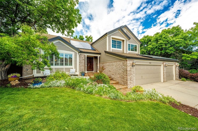 view of front of property with brick siding, solar panels, concrete driveway, a garage, and a front lawn