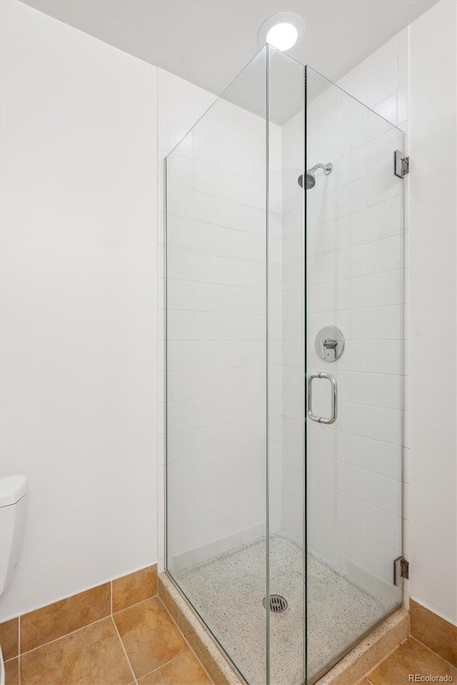 2958 Syracuse St Unit 316, Denver, CO 80238 - full bath with toilet, a shower stall, and tile patterned flooring