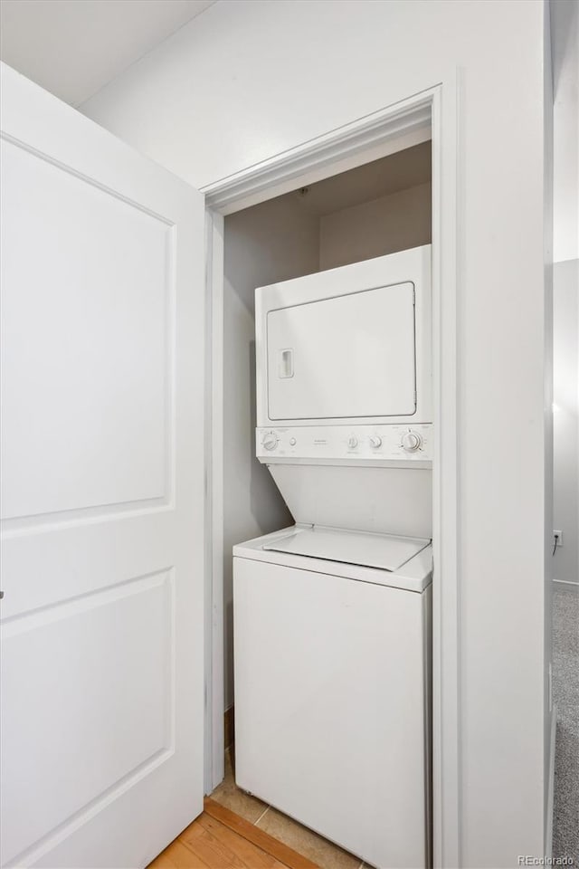 2958 Syracuse St Unit 316, Denver, CO 80238 - washroom with estacked washer and dryer and light wood-style floors