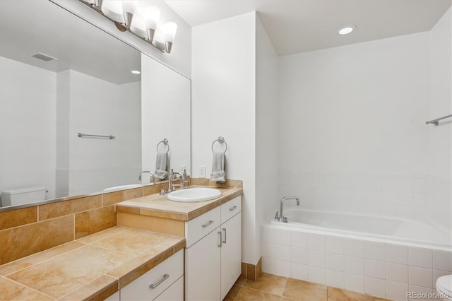 2958 Syracuse St Unit 316, Denver, CO 80238 - bathroom featuring toilet, tiled bath, vanity, and tile patterned floors