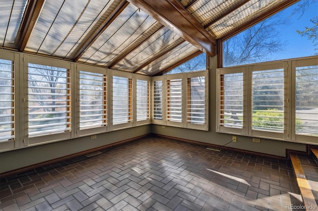 unfurnished sunroom featuring healthy amount of natural light and baseboards