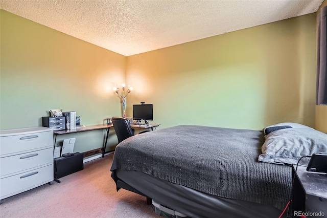 bedroom with carpet, a textured ceiling, and an office area