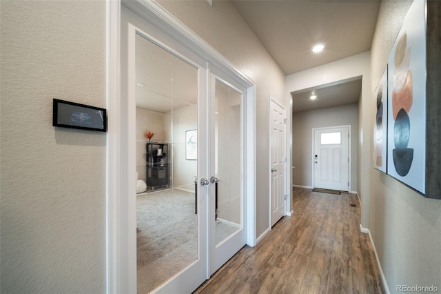 17028 Osage St, Broomfield, CO 80023 - corridor with wood finished floors, a textured wall, and french doors