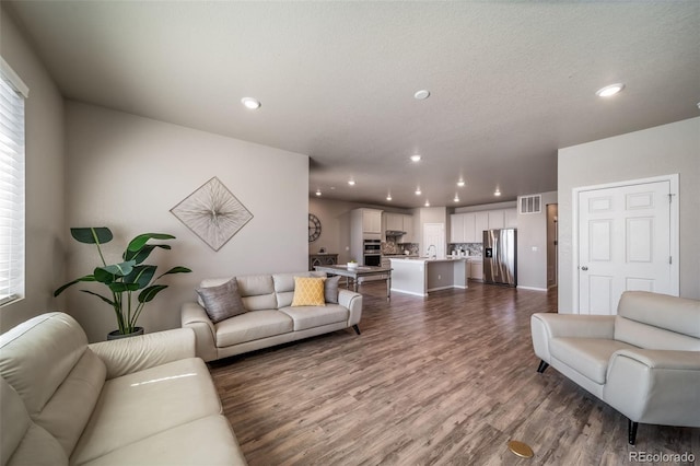 17028 Osage St, Broomfield, CO 80023 - living room featuring recessed lighting, dark wood finished floors, and healthy amount of natural light