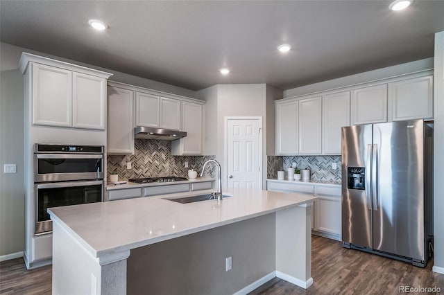 17028 Osage St, Broomfield, CO 80023 - kitchen with appliances with stainless steel finishes, dark wood-style floors, backsplash, and recessed lighting