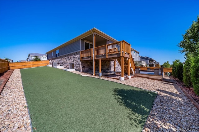 17028 Osage St, Broomfield, CO 80023 - rear view of house with a wooden deck, a fenced backyard, and stone siding
