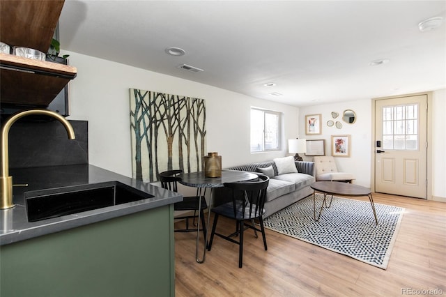 living area featuring recessed lighting, visible vents, and light wood-style flooring