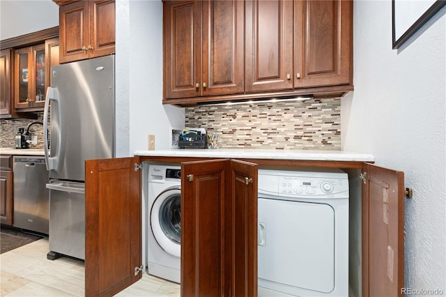 laundry room featuring laundry area, a sink, and washer / dryer