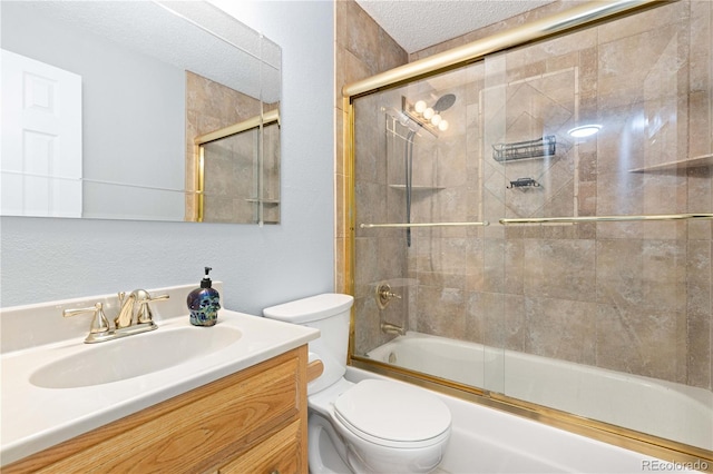 full bathroom featuring toilet, a textured ceiling, vanity, and bath / shower combo with glass door