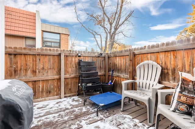 snow covered deck with fence