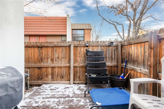 snow covered patio featuring fence