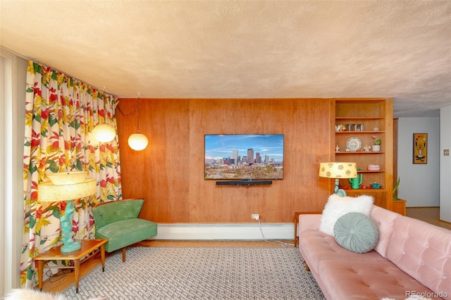 carpeted living area featuring a baseboard heating unit, wood walls, and a textured ceiling