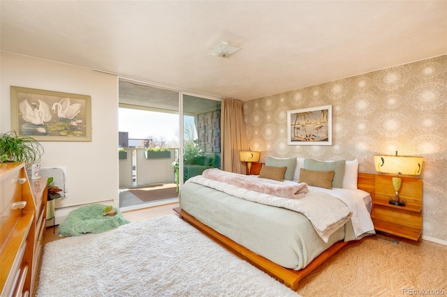 bedroom with access to outside, carpet flooring, baseboards, and wallpapered walls