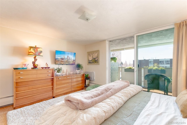 bedroom featuring a baseboard radiator, access to outside, and expansive windows