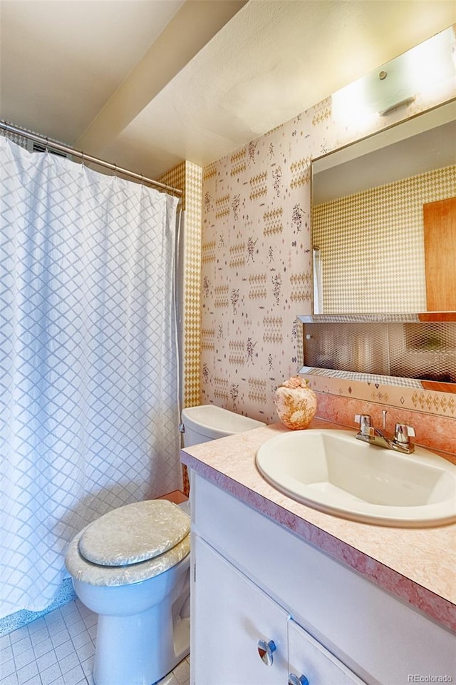 bathroom featuring tile patterned flooring, curtained shower, vanity, toilet, and wallpapered walls