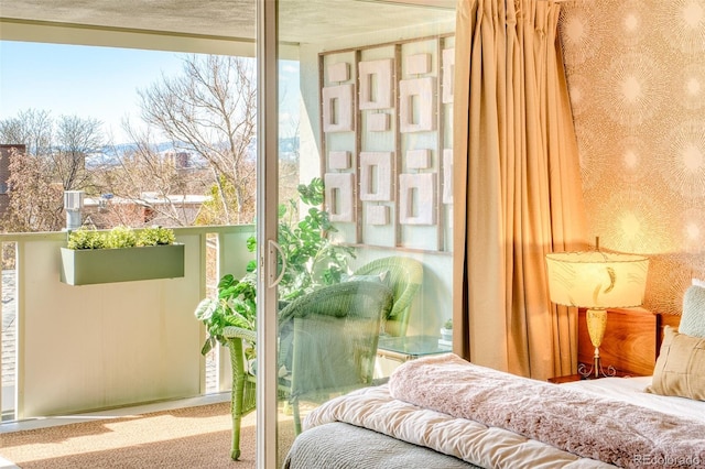 carpeted bedroom featuring wallpapered walls