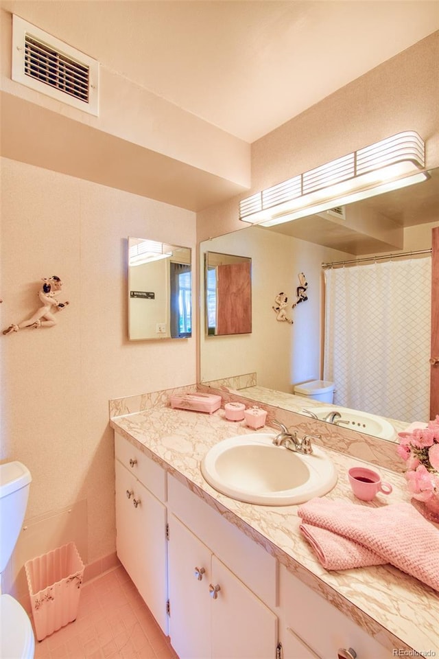 full bath featuring visible vents, tile patterned flooring, toilet, and vanity
