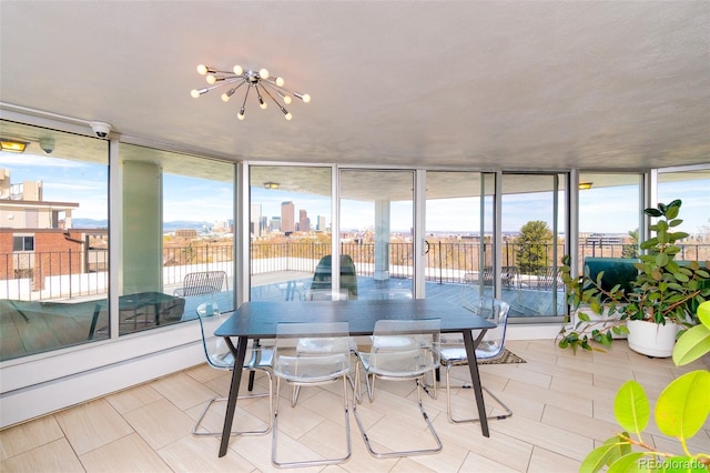 sunroom featuring a chandelier