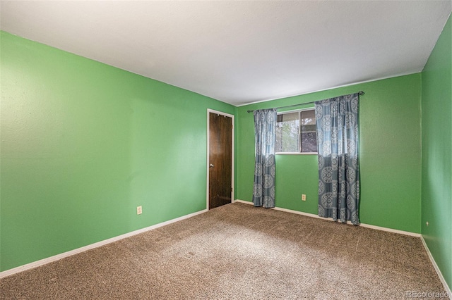 carpeted empty room with baseboards