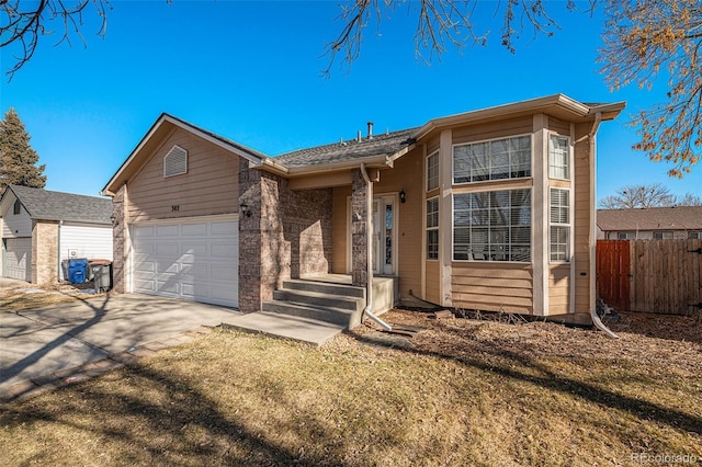 ranch-style house with a garage and a front lawn