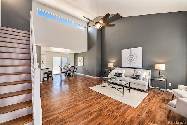 living room featuring ceiling fan, hardwood / wood-style flooring, and high vaulted ceiling